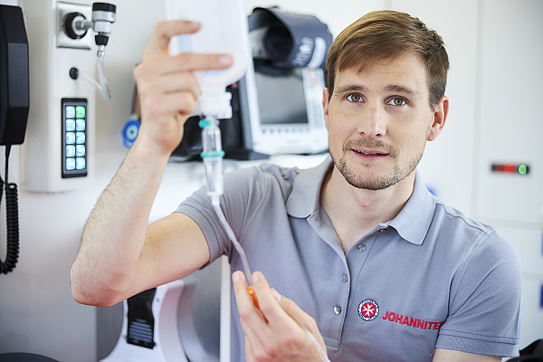Notfallsanitäter hält Infusionsflasche
