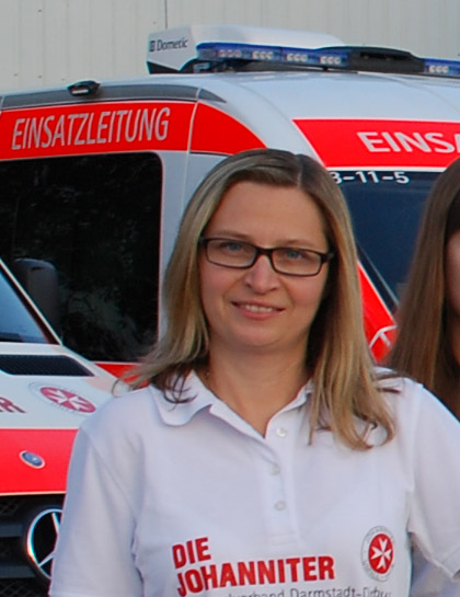 Eva Ludwar vor einem Einsatzfahrzeug