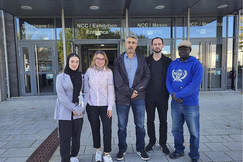 Gruppenbild der Teilnehmer vor der Eingangstür des Messebereiches