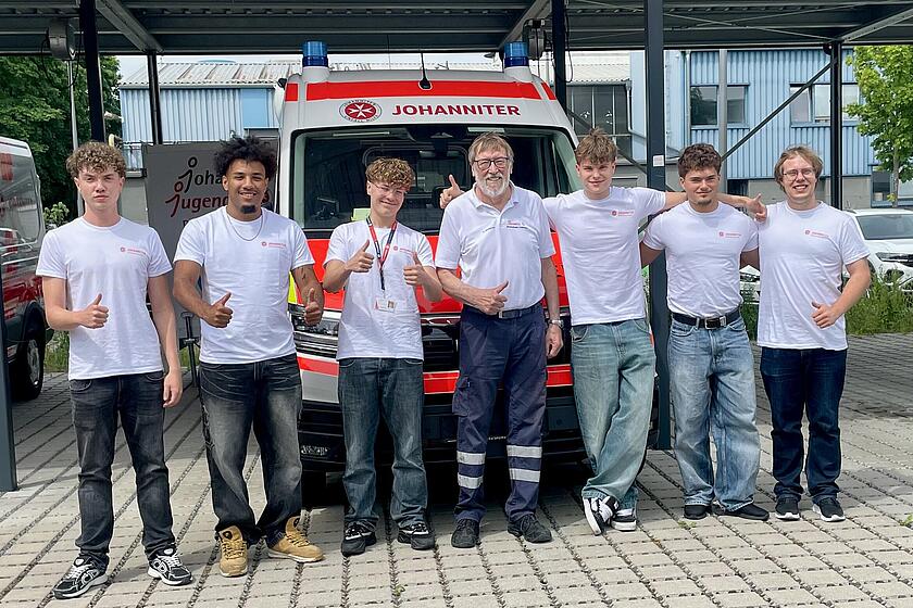 Die Wesser Werbepersonen machen freudig mit dem Ortsbeauftragten Lauf der Johanniter ein Gruppenfoto. 